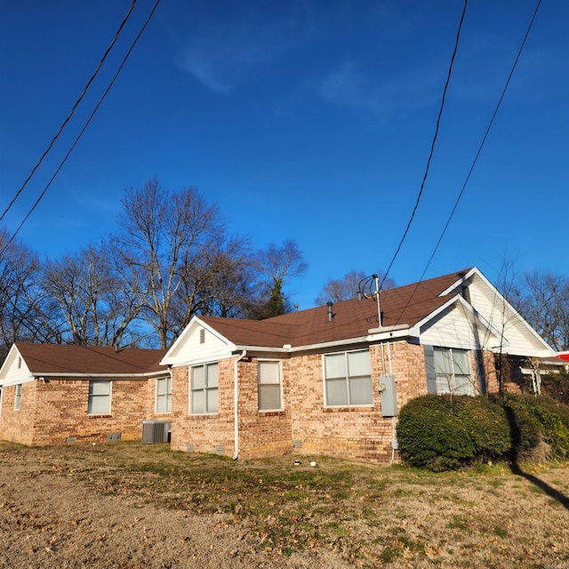 view of property exterior featuring a lawn and central air condition unit