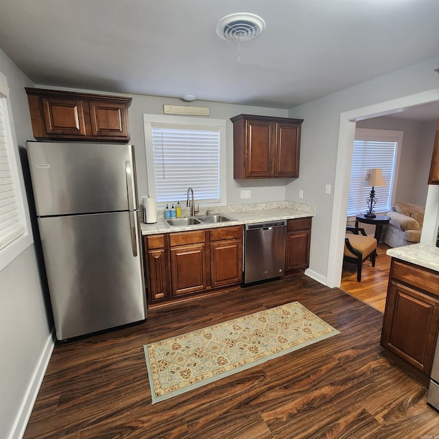 506 W Pleasure, Searcy, AR 72143 - kitchen featuring stainless steel appliances, dark hardwood / wood-style floors, light stone countertops, and sink
