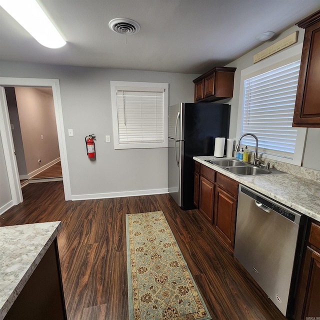 506 W Pleasure, Searcy, AR 72143 - kitchen featuring stainless steel appliances, dark brown cabinets, sink, and dark wood-type flooring