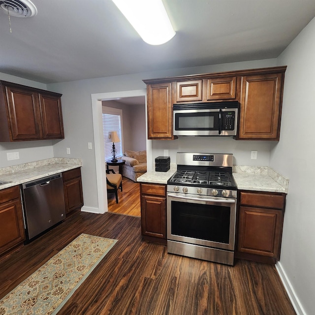 506 W Pleasure, Searcy, AR 72143 - kitchen featuring stainless steel appliances and dark hardwood / wood-style flooring
