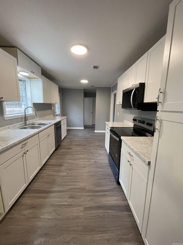 kitchen featuring dark hardwood / wood-style floors, white cabinetry, sink, stainless steel dishwasher, and electric range