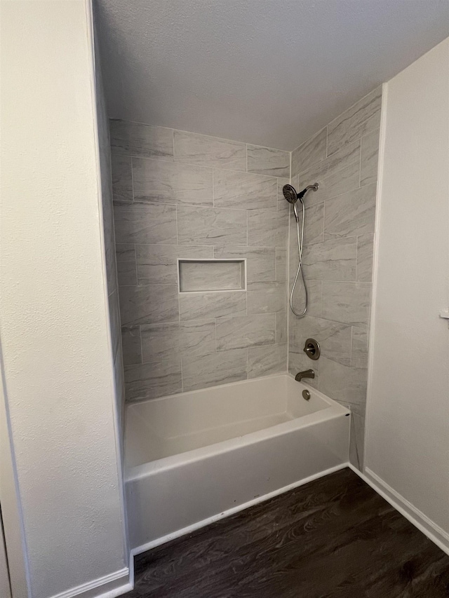 bathroom with tiled shower / bath combo and wood-type flooring