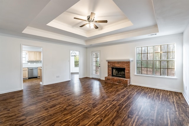 unfurnished living room with dark hardwood / wood-style floors, a fireplace, and a raised ceiling