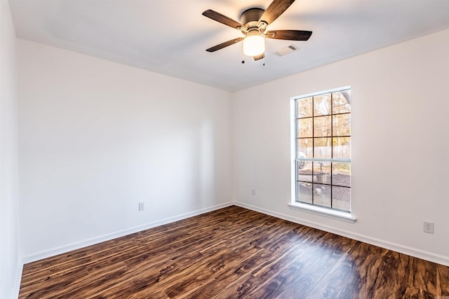 spare room featuring ceiling fan and dark hardwood / wood-style floors