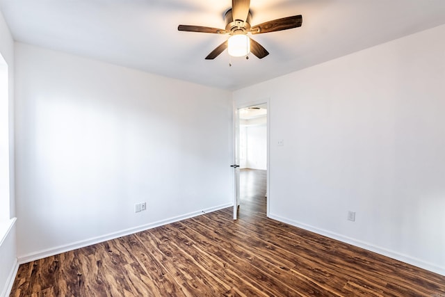 unfurnished room with ceiling fan and dark hardwood / wood-style flooring