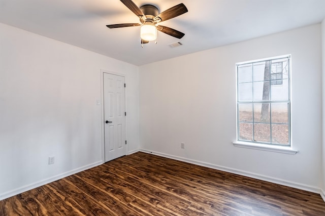 empty room featuring ceiling fan and dark hardwood / wood-style flooring