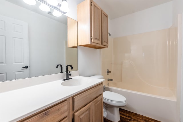 full bathroom featuring vanity, hardwood / wood-style floors, bathing tub / shower combination, and toilet