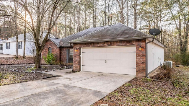 view of front of home with cooling unit and a garage