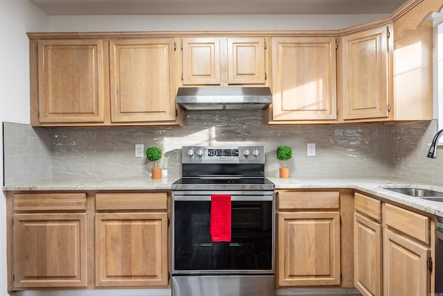 kitchen featuring light brown cabinetry, sink, tasteful backsplash, light stone counters, and stainless steel appliances