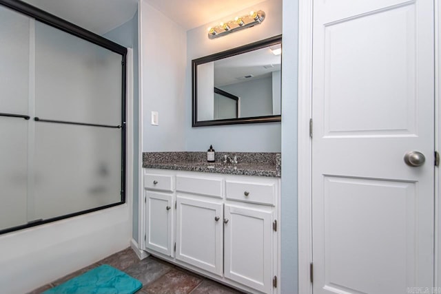 bathroom featuring enclosed tub / shower combo and vanity