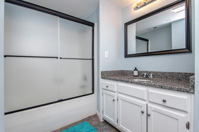 bathroom featuring enclosed tub / shower combo and vanity