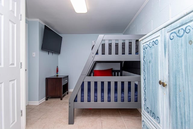 tiled bedroom featuring crown molding