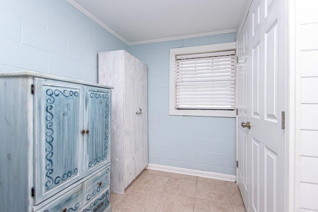 bathroom featuring ornamental molding and tile patterned flooring