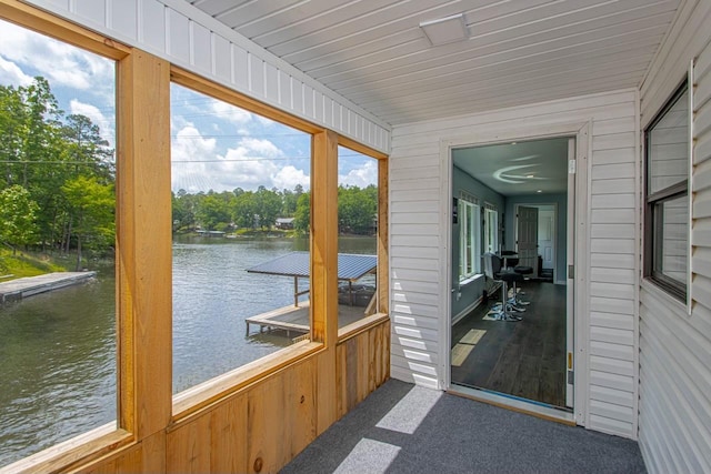 sunroom / solarium with a water view