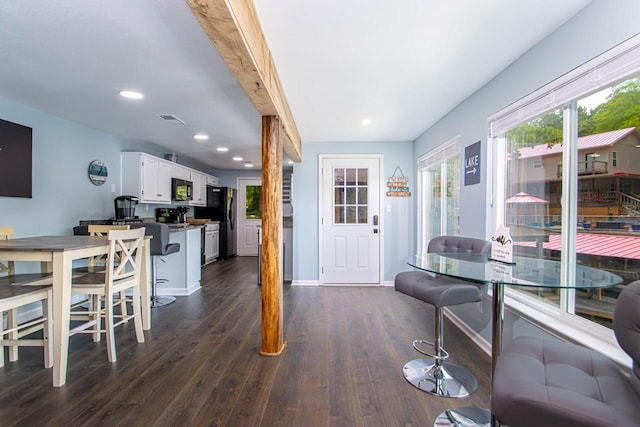 interior space featuring beam ceiling and dark wood-type flooring