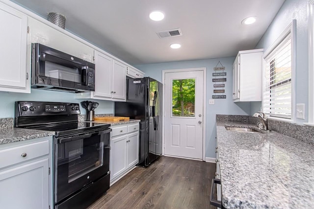 kitchen with sink, white cabinetry, plenty of natural light, dark hardwood / wood-style floors, and black appliances