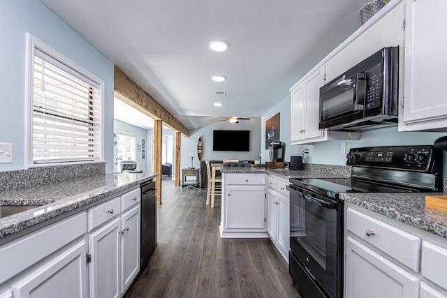 kitchen with light stone counters, black appliances, and white cabinets