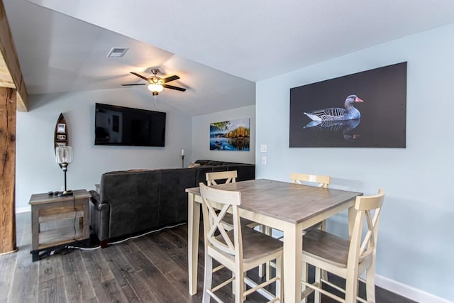 dining area featuring dark hardwood / wood-style flooring, lofted ceiling, and ceiling fan