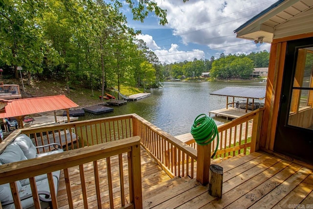 wooden deck with a water view and a dock