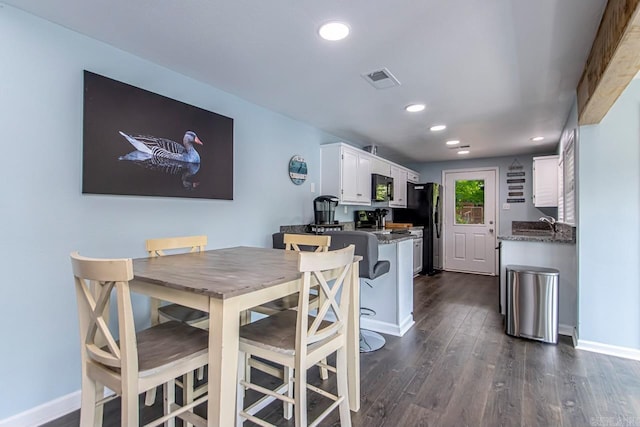 dining area with dark hardwood / wood-style flooring