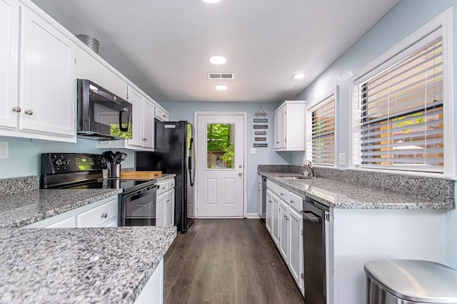 kitchen with white cabinetry, sink, black electric range, and light stone countertops