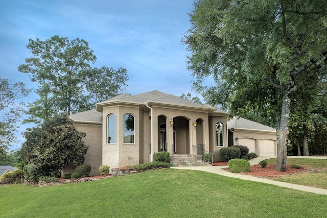 mediterranean / spanish-style home featuring a garage and a front yard