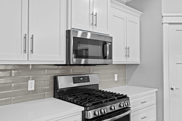 kitchen featuring white cabinetry, appliances with stainless steel finishes, and backsplash