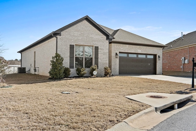 view of front of house with central AC and a garage