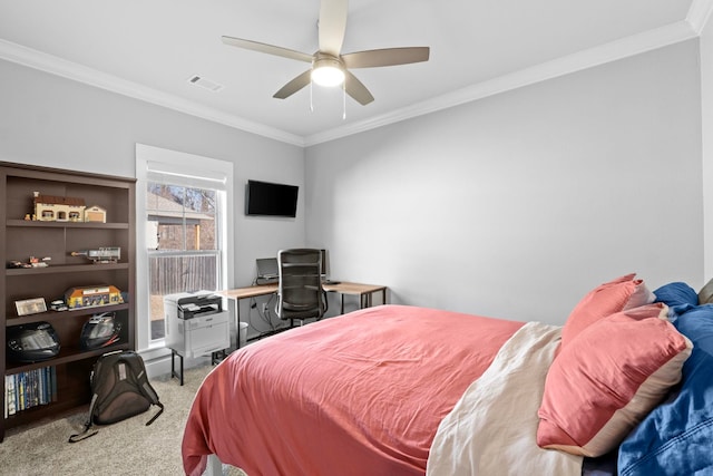 carpeted bedroom with ornamental molding and ceiling fan