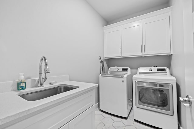 laundry area with cabinets, sink, and washer and dryer