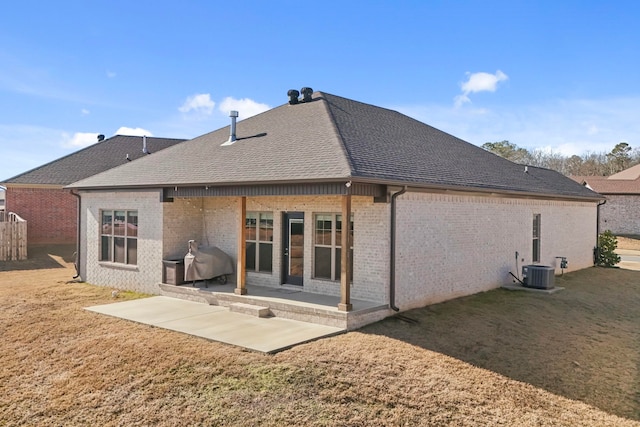 back of house with a yard, a patio, and central air condition unit