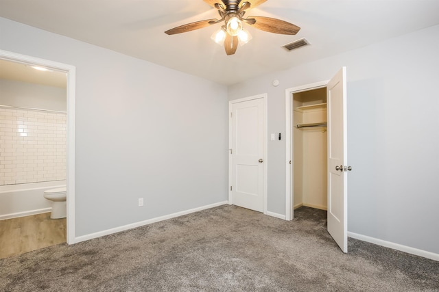 unfurnished bedroom with ceiling fan, ensuite bath, carpet floors, and a closet