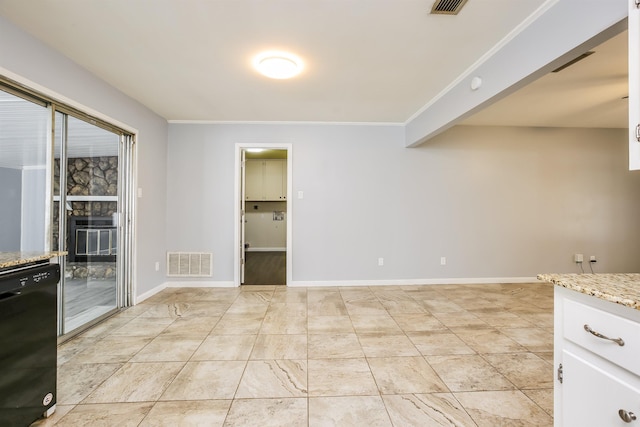 interior space featuring light stone counters, a stone fireplace, dishwasher, and white cabinets