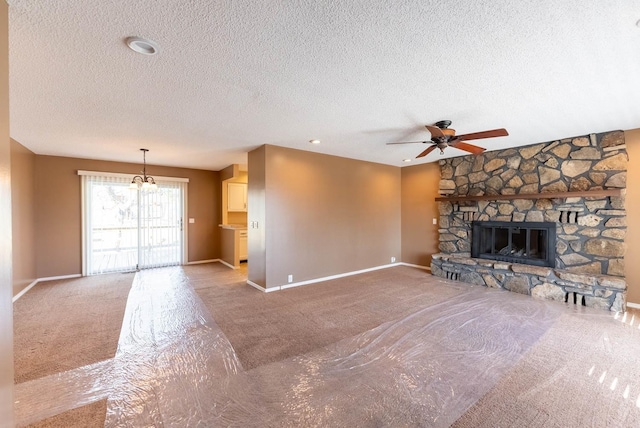 unfurnished living room featuring a textured ceiling, a fireplace, and ceiling fan