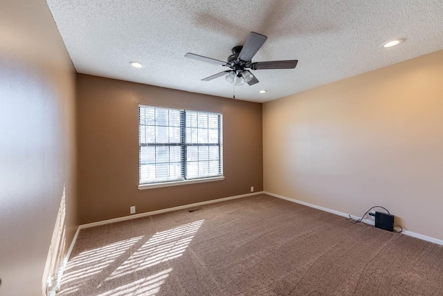 empty room with a textured ceiling, carpet floors, and ceiling fan