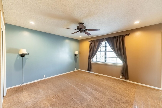 unfurnished room featuring ceiling fan, carpet, and a textured ceiling