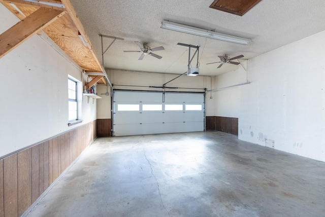 garage with a garage door opener and wood walls