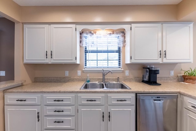 kitchen featuring white cabinetry, dishwasher, and sink