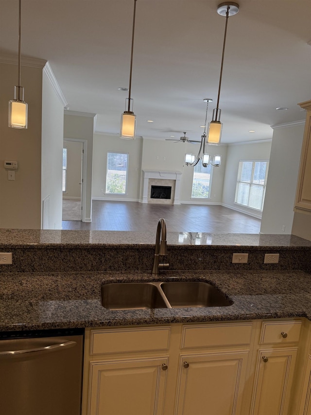 kitchen featuring sink, stainless steel dishwasher, and decorative light fixtures