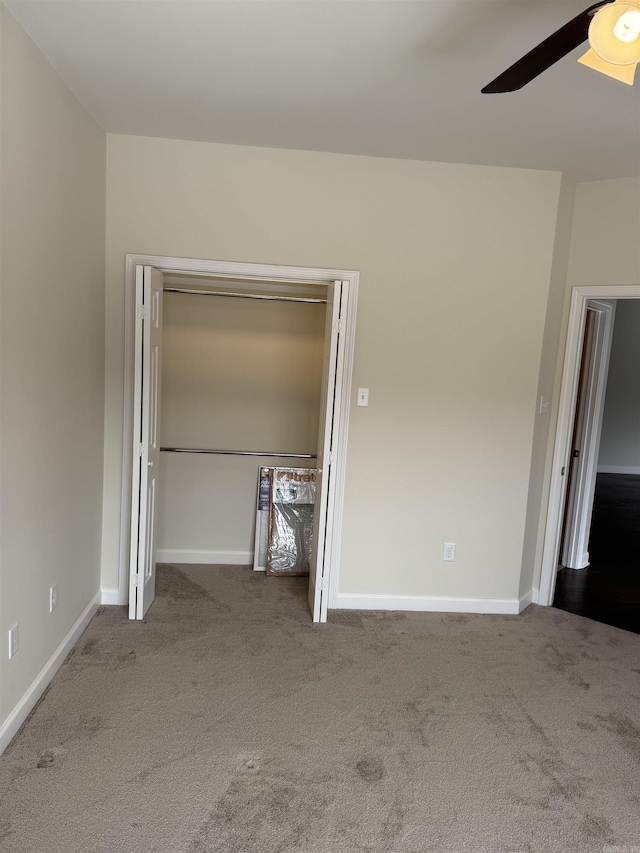 interior space with ceiling fan, a closet, and carpet