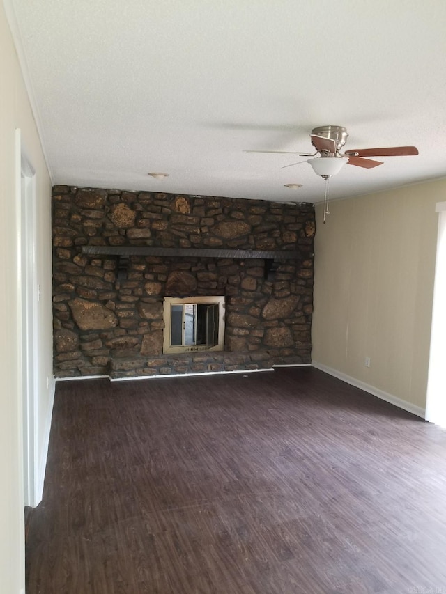 unfurnished living room with ceiling fan, dark hardwood / wood-style floors, and a fireplace