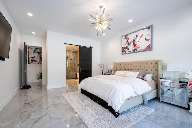 bedroom featuring a barn door, a chandelier, and ensuite bath