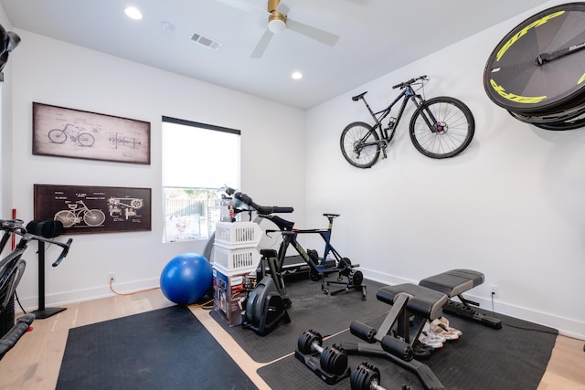 workout area featuring ceiling fan and hardwood / wood-style floors