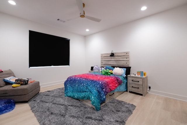 bedroom with light hardwood / wood-style floors and ceiling fan