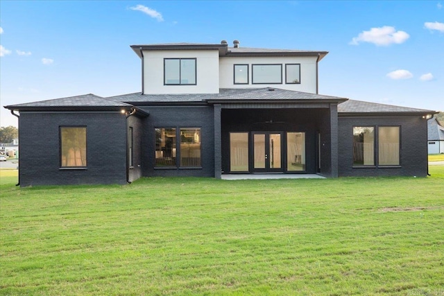 rear view of house featuring a yard