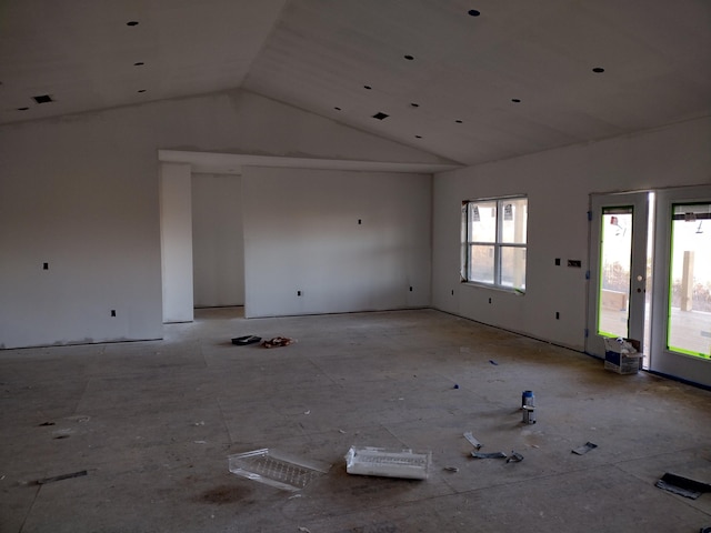 unfurnished living room featuring high vaulted ceiling