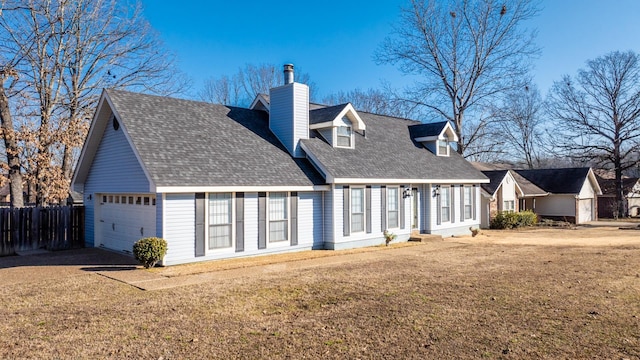 cape cod-style house featuring a garage and a front yard