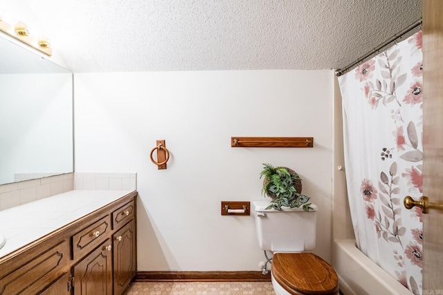 full bathroom with vanity, shower / tub combo with curtain, a textured ceiling, and toilet