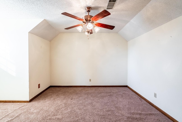 bonus room featuring lofted ceiling, ceiling fan, a textured ceiling, and carpet flooring