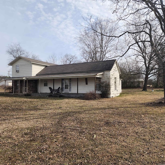 rear view of property with a yard and covered porch